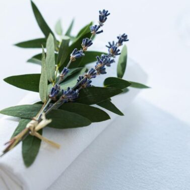 Elegant white napkin with lavender sprig, creating a welcoming table setting.