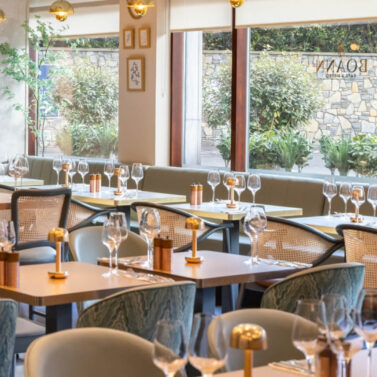 Elegant dining area with neatly set tables and warm lighting.