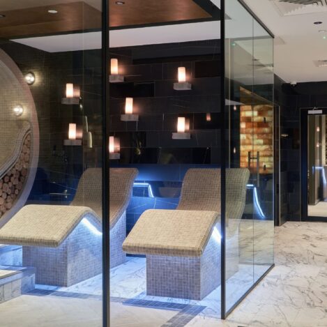 Elegant spa lounge with plush recliners and warm lighting creating a serene retreat.