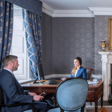 Welcoming hotel reception area with friendly staff and elegant decor.