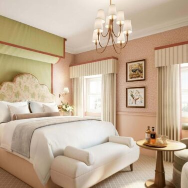 Elegant hotel room with plush bed, soft lighting, and cosy décor for a relaxing stay.